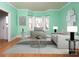 Stylish living room with ample seating, a modern coffee table, and bright light coming in from three large windows at 7007 Chapparall Ln, Charlotte, NC 28215