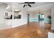 Open-concept space features living room and kitchen, with hardwood floors, plenty of natural light and neutral palette at 7007 Chapparall Ln, Charlotte, NC 28215
