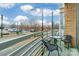 Condo balcony view of city with table and two chairs overlooking a parking lot and street at 710 W Trade St # 314, Charlotte, NC 28202