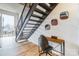 Modern interior showcases a desk area, unique mirror art, and metal stairs leading to a lofted space at 710 W Trade St # 314, Charlotte, NC 28202