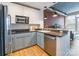Well-lit kitchen featuring stainless steel appliances, modern cabinetry and a brick accent wall at 710 W Trade St # 314, Charlotte, NC 28202