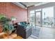 Open living area featuring exposed brick wall, hardwood floors, and an abundance of natural light at 710 W Trade St # 314, Charlotte, NC 28202