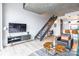 Bright living room with a modern staircase and open kitchen at 710 W Trade St # 314, Charlotte, NC 28202