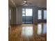 Open living room with a sliding glass door leading to a balcony with an overhead ceiling fan at 718 W Trade St # 302, Charlotte, NC 28202