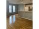 Open living room with hardwood floors, bright windows, and adjacent kitchen bar for easy entertaining at 718 W Trade St # 302, Charlotte, NC 28202