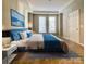 Comfortable bedroom with a large window, offering natural light at 718 W Trade St # 302, Charlotte, NC 28202