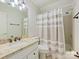 Bathroom with granite vanity, neutral tile, and a shower/tub with curtain at 7329 Kennington Ct, Charlotte, NC 28270