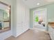 Bathroom with linen cabinets, double vanity, and tile floors that leads into the main bedroom at 7329 Kennington Ct, Charlotte, NC 28270
