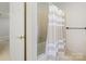 Bathroom with neutral tile, shower with tub, shower curtain and bronze hardware at 7329 Kennington Ct, Charlotte, NC 28270