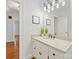 Bathroom vanity featuring granite countertops, white cabinetry, and modern lighting fixtures at 7329 Kennington Ct, Charlotte, NC 28270