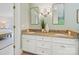 Bathroom featuring double vanity, decorative mirrors, tile floors, and modern lighting at 7329 Kennington Ct, Charlotte, NC 28270