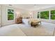 Bright bedroom with large windows, a ceiling fan, and neutral decor at 7329 Kennington Ct, Charlotte, NC 28270