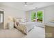 Bright bedroom features a bed and large window overlooking lush landscaping at 7329 Kennington Ct, Charlotte, NC 28270