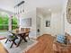 Cozy dining area with rustic table, bench seating, and large windows for natural light and view into laundry area at 7329 Kennington Ct, Charlotte, NC 28270