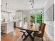 Bright dining area adjacent to the kitchen, featuring a wooden table, wicker chairs, and views of the outdoor deck at 7329 Kennington Ct, Charlotte, NC 28270