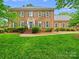 Charming brick home features lush landscaping, a well-manicured lawn, gray shutters, and an elegant entrance at 7329 Kennington Ct, Charlotte, NC 28270