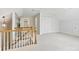 Hallway and staircase of bright home features white paint, carpet and wooden railing at 7329 Kennington Ct, Charlotte, NC 28270