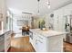 Kitchen island with microwave, granite countertop, white cabinets, and stainless steel refrigerator at 7329 Kennington Ct, Charlotte, NC 28270
