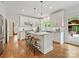 Modern kitchen with white cabinets, stainless steel appliances, marble countertops and a center island with seating at 7329 Kennington Ct, Charlotte, NC 28270