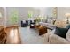 Spacious living room with neutral furniture, hardwood floors, and plantation shutters at 7329 Kennington Ct, Charlotte, NC 28270