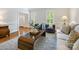 Living room boasts hardwood floors, neutral furniture, and shuttered windows at 7329 Kennington Ct, Charlotte, NC 28270