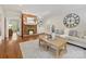 Living room features a brick fireplace, built in shelving, neutral sofa, and hardwood floors at 7329 Kennington Ct, Charlotte, NC 28270