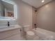 Bathroom featuring a tiled shower/tub, modern vanity, and elegant fixtures at 908 Davenport St, Charlotte, NC 28208
