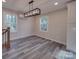 Light-filled dining room with modern light fixture, windows, and staircase at 908 Davenport St, Charlotte, NC 28208