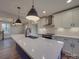 Spacious kitchen featuring white cabinets, stainless steel appliances, and quartz countertops at 908 Davenport St, Charlotte, NC 28208