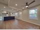Open living room with hardwood floors and recessed lighting, connecting to a contemporary kitchen area at 908 Davenport St, Charlotte, NC 28208