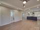 Spacious living area leading to a modern kitchen, with hardwood floors and a seamless design at 908 Davenport St, Charlotte, NC 28208