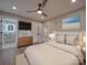 Relaxing main bedroom with hardwood floors, ceiling fan, and ensuite bathroom access at 908 Davenport St, Charlotte, NC 28208