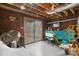Unfinished basement with exposed brick and sliding glass door, offering ample storage or workshop space at 9257 Mull Rd, Vale, NC 28168