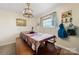 Cozy dining area with a farmhouse-style table and bench seating, illuminated by a unique chandelier at 9257 Mull Rd, Vale, NC 28168