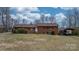 Well-maintained brick home with a cozy carport and manicured bushes at 9257 Mull Rd, Vale, NC 28168