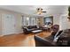 Inviting living room with hardwood floors, comfortable leather seating, and natural light from large windows at 9257 Mull Rd, Vale, NC 28168