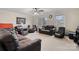 Bright living room with neutral carpet, ceiling fan, and plenty of natural light from the many windows at 9257 Mull Rd, Vale, NC 28168
