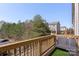 Balcony with outdoor seating, offering a tranquil view of lush greenery and neighborhood landscape at 9330 Ainslie Downs St, Charlotte, NC 28273
