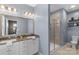 Well-lit bathroom features double sinks, granite countertops, and a standing glass shower at 9330 Ainslie Downs St, Charlotte, NC 28273