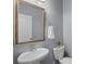A half bathroom featuring pedestal sink, mirror, and decorative accents, providing a convenient space at 9330 Ainslie Downs St, Charlotte, NC 28273