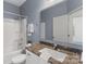 A bathroom features a vanity with granite counter, tub-shower, and neutral walls at 9330 Ainslie Downs St, Charlotte, NC 28273