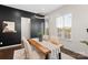 Bright dining room features a modern light fixture, black accent wall, and a natural wood table at 9330 Ainslie Downs St, Charlotte, NC 28273