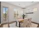 Bright dining room with modern lighting, a stylish table, and access to a deck at 9330 Ainslie Downs St, Charlotte, NC 28273
