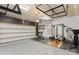 A spacious two car garage with work out area and metal shelving units, for organization and storage at 9330 Ainslie Downs St, Charlotte, NC 28273