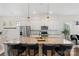 Bright kitchen features an oversized island with barstool seating and modern pendant lighting at 9330 Ainslie Downs St, Charlotte, NC 28273