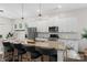 Bright kitchen featuring an oversized island with barstool seating and modern pendant lighting at 9330 Ainslie Downs St, Charlotte, NC 28273