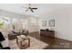 Bright, spacious living room offers ample natural light, hardwood floors, and a modern ceiling fan at 9330 Ainslie Downs St, Charlotte, NC 28273