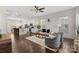 Open-concept living space with hardwood floors, ample seating, and a modern kitchen island at 9330 Ainslie Downs St, Charlotte, NC 28273