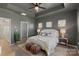 Comfortable main bedroom with a tray ceiling features neutral decor and soft, natural lighting at 9330 Ainslie Downs St, Charlotte, NC 28273