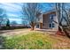 Spacious backyard featuring a large patio, green lawn, and mature trees, perfect for outdoor entertaining and relaxation at 102 Brewster Ct, Mooresville, NC 28115